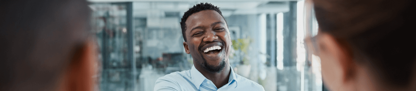 Man shaking hands and laughing