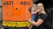 Woman holding child in front of train car