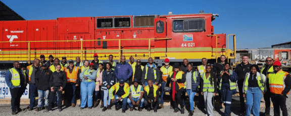 Group in front of train engine