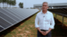 standing in front of solar panels
