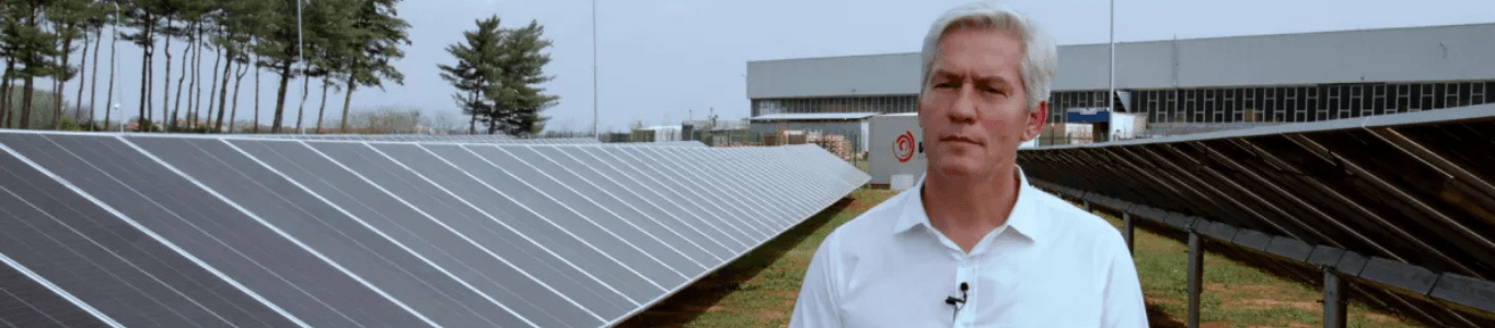 standing in front of solar panels