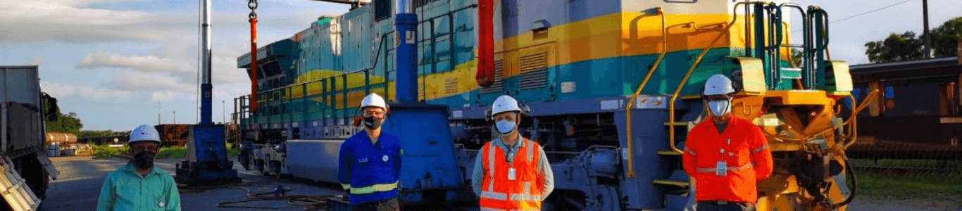 Braulio with co-workers in front of Wabtec train engine