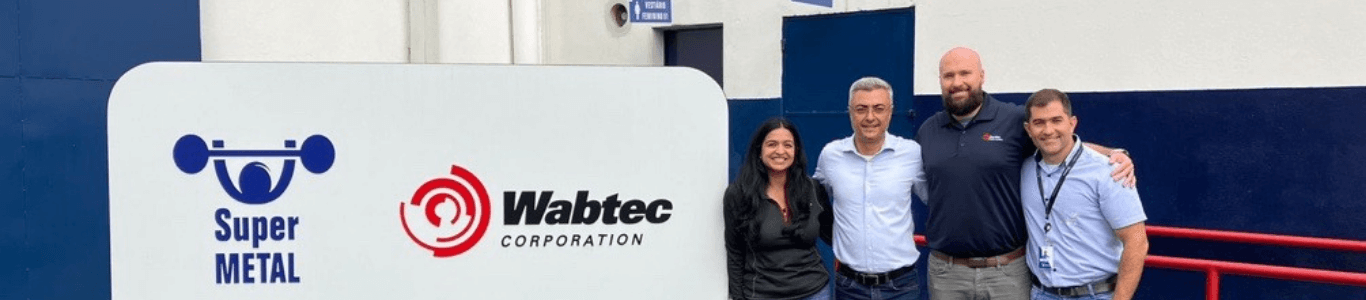Priyanka with her co-workers by Wabtec sign